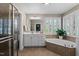 The primary bathroom features a soaking tub, double vanity with white cabinets, and a separate tiled shower enclosure at 1401 Marshall Farm St, Wake Forest, NC 27587