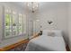 Bright bedroom with a queen bed, natural light from a large window and stylish decor at 1401 Marshall Farm St, Wake Forest, NC 27587