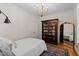Comfortable bedroom features an antique cabinet, mirror, and hardwood floors at 1401 Marshall Farm St, Wake Forest, NC 27587