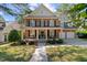 Charming brick home with a welcoming front porch, black shutters, and manicured landscaping at 1401 Marshall Farm St, Wake Forest, NC 27587