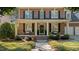 Charming brick home with manicured landscaping and inviting front porch with black door and seating at 1401 Marshall Farm St, Wake Forest, NC 27587
