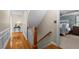 Hallway leading to the bedroom featuring hardwood floors, white trim, and an inviting view into the bedroom at 1401 Marshall Farm St, Wake Forest, NC 27587