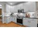Bright kitchen featuring white cabinetry, stainless steel appliances, and granite countertops at 1401 Marshall Farm St, Wake Forest, NC 27587