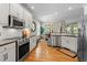 Bright kitchen with stainless steel appliances, a view to the dining room, and ample counter space at 1401 Marshall Farm St, Wake Forest, NC 27587