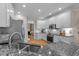 Well-lit kitchen with granite countertops, stainless steel appliances, and white cabinetry at 1401 Marshall Farm St, Wake Forest, NC 27587