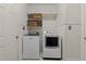Convenient laundry room equipped with a modern washer, dryer, and shelving for storage at 1401 Marshall Farm St, Wake Forest, NC 27587