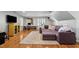 Spacious living room featuring a large sectional sofa, hardwood floors, and a home office nook at 1401 Marshall Farm St, Wake Forest, NC 27587