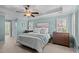 Calming main bedroom with tray ceilings, neutral decor, and two windows offering an abundance of natural light at 1401 Marshall Farm St, Wake Forest, NC 27587