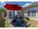 Backyard patio area with blue Adirondack chairs, great for relaxing and outdoor entertainment at 1410 Osborne Dr, Burlington, NC 27215