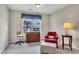 Well-lit bedroom featuring a comfortable seating area with views from the window at 1410 Osborne Dr, Burlington, NC 27215