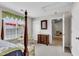 Bedroom featuring a four poster bed, ample natural light, and a seating area at 1410 Osborne Dr, Burlington, NC 27215
