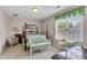 Comfortable bedroom with a four-poster bed, complemented by a sitting area with bright, natural lighting at 1410 Osborne Dr, Burlington, NC 27215