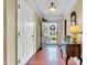 Welcoming foyer with hardwood floors, coat closet, and decorative table with mirror accent at 1410 Osborne Dr, Burlington, NC 27215