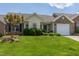Charming brick home featuring a well-manicured lawn, mature landscaping, and a welcoming front entrance at 1410 Osborne Dr, Burlington, NC 27215