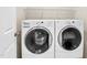 Washer and dryer in laundry room featuring storage and modern appliances at 1410 Osborne Dr, Burlington, NC 27215