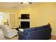 Bright living room with fireplace, large sofa, and French doors at 1410 Osborne Dr, Burlington, NC 27215