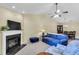 Comfortable living space featuring a fireplace, neutral carpet, and views of the dining area at 1410 Osborne Dr, Burlington, NC 27215