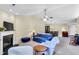 Spacious living room with fireplace, ceiling fan, neutral carpet, and views of the dining area at 1410 Osborne Dr, Burlington, NC 27215