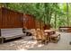 Outdoor deck area with wooden furniture, string lights, and privacy fence at 1509 Cumberland Rd, Chapel Hill, NC 27514