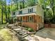Angle view of the two-story home, showcasing brick facade, covered porch, and stone steps at 1509 Cumberland Rd, Chapel Hill, NC 27514