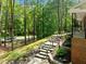 Beautiful stone staircase leading to the home's entrance, surrounded by lush greenery and professional landscaping at 1509 Cumberland Rd, Chapel Hill, NC 27514
