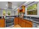 Modern kitchen with updated appliances, tile backsplash, and natural light from windows at 1509 Cumberland Rd, Chapel Hill, NC 27514