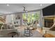 Cozy living room showcasing a stone fireplace, bay window, and stylish furnishings at 1509 Cumberland Rd, Chapel Hill, NC 27514