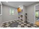 Room with checkerboard tile flooring, built-in shelving, and a large window at 1509 Cumberland Rd, Chapel Hill, NC 27514