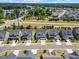 A beautiful aerial shot of houses, tree lines, and a sidewalk on a bright sunny day at 1513 Armscroft Lane, Apex, NC 27502