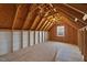 An unfinished attic space with wooden beams and plywood ready to be customized to your needs at 1513 Armscroft Lane, Apex, NC 27502