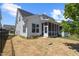 A backyard with a black metal fence, grass that has been seeded, and a screened-in porch at 1513 Armscroft Lane, Apex, NC 27502