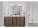 Bright bathroom featuring double vanities, a large mirror, and tiled flooring at 1513 Armscroft Lane, Apex, NC 27502