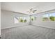 Large bedroom with three windows, a ceiling fan, and carpeted flooring at 1513 Armscroft Lane, Apex, NC 27502