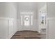 Bright foyer featuring a modern front door, wood-look floors, and classic wainscoting at 1513 Armscroft Lane, Apex, NC 27502