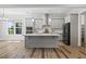 Spacious kitchen featuring an island, stainless steel appliances, and natural lighting at 1513 Armscroft Lane, Apex, NC 27502