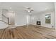 Living room featuring a fireplace, modern trim, stairs, and wood-look floors at 1513 Armscroft Lane, Apex, NC 27502