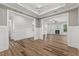 Open-concept living room with a fireplace, wood-look floors, and modern trim at 1513 Armscroft Lane, Apex, NC 27502