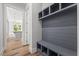 Mudroom entry featuring built-in storage and bench with view to kitchen at 1513 Armscroft Lane, Apex, NC 27502