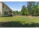 Well-maintained backyard features lush lawn, mature trees and covered patio at 1605 Sassafras St, Durham, NC 27712
