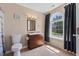 Bright bathroom with decorative tile, granite counters and window with wooded view at 1605 Sassafras St, Durham, NC 27712