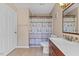 Bathroom with shower-tub combination with decorative tile and single sink vanity at 1605 Sassafras St, Durham, NC 27712