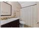 Cozy bathroom featuring double vanity, framed mirror and neutral-toned tile details at 1605 Sassafras St, Durham, NC 27712