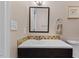 Bathroom featuring a modern vanity, framed mirror, and earth-toned accent tiles at 1605 Sassafras St, Durham, NC 27712