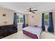 Cozy bedroom with natural light, ceiling fan, and large window with tree view at 1605 Sassafras St, Durham, NC 27712