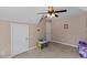 Bright bedroom with ceiling fan, neutral paint, and carpeting at 1605 Sassafras St, Durham, NC 27712