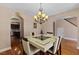 A dining room with hardwood floors, a modern table, and access to the kitchen and living room at 1605 Sassafras St, Durham, NC 27712