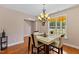 A bright dining room with large windows, a modern table, and hardwood floors at 1605 Sassafras St, Durham, NC 27712