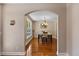 The dining room features hardwood floors, an elegant chandelier, and natural light from a nearby window at 1605 Sassafras St, Durham, NC 27712