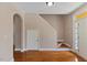 Hardwood floors lead to the upper staircase with adjacent access to a front door and other rooms at 1605 Sassafras St, Durham, NC 27712