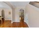 The entryway features hardwood floors, an arched doorway, and access to the upper level staircase at 1605 Sassafras St, Durham, NC 27712